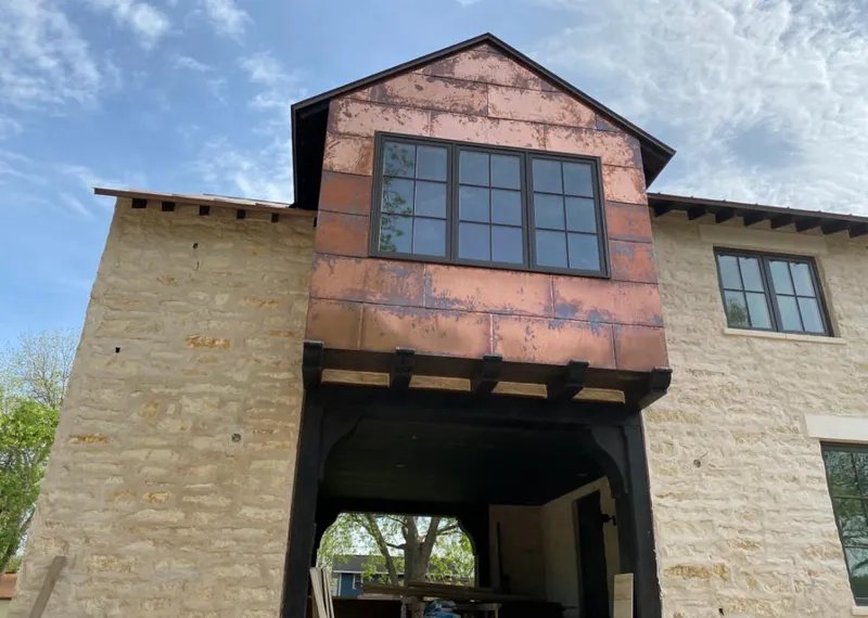 Copper metal panel facade on a stone building for Metal Roof Coating in St. Rose